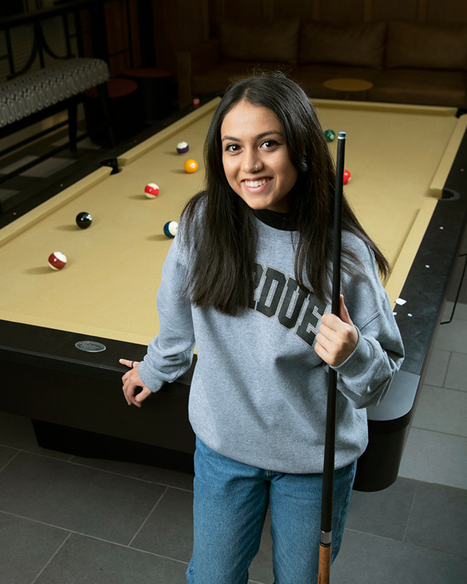 A Purdue student stands at one of the PMU’s new pool tables