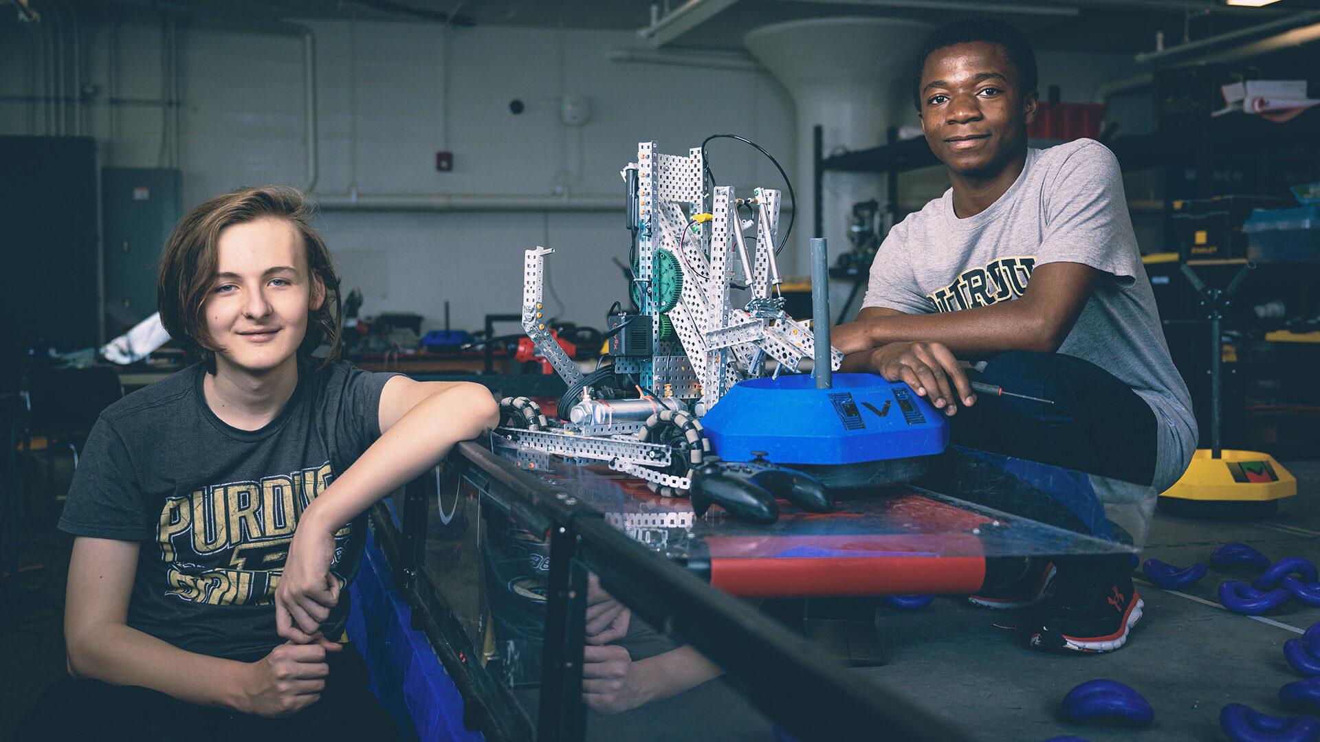 Aurora Lakey and Asunami Gregoire Kalupala, both freshmen at Purdue Polytechnic High School Schweitzer Center at Englewood in Indianapolis, work on their VEX robot in preparation for the VEX Robotics World Championships in Dallas. (Purdue University photo/Charles Jischke)