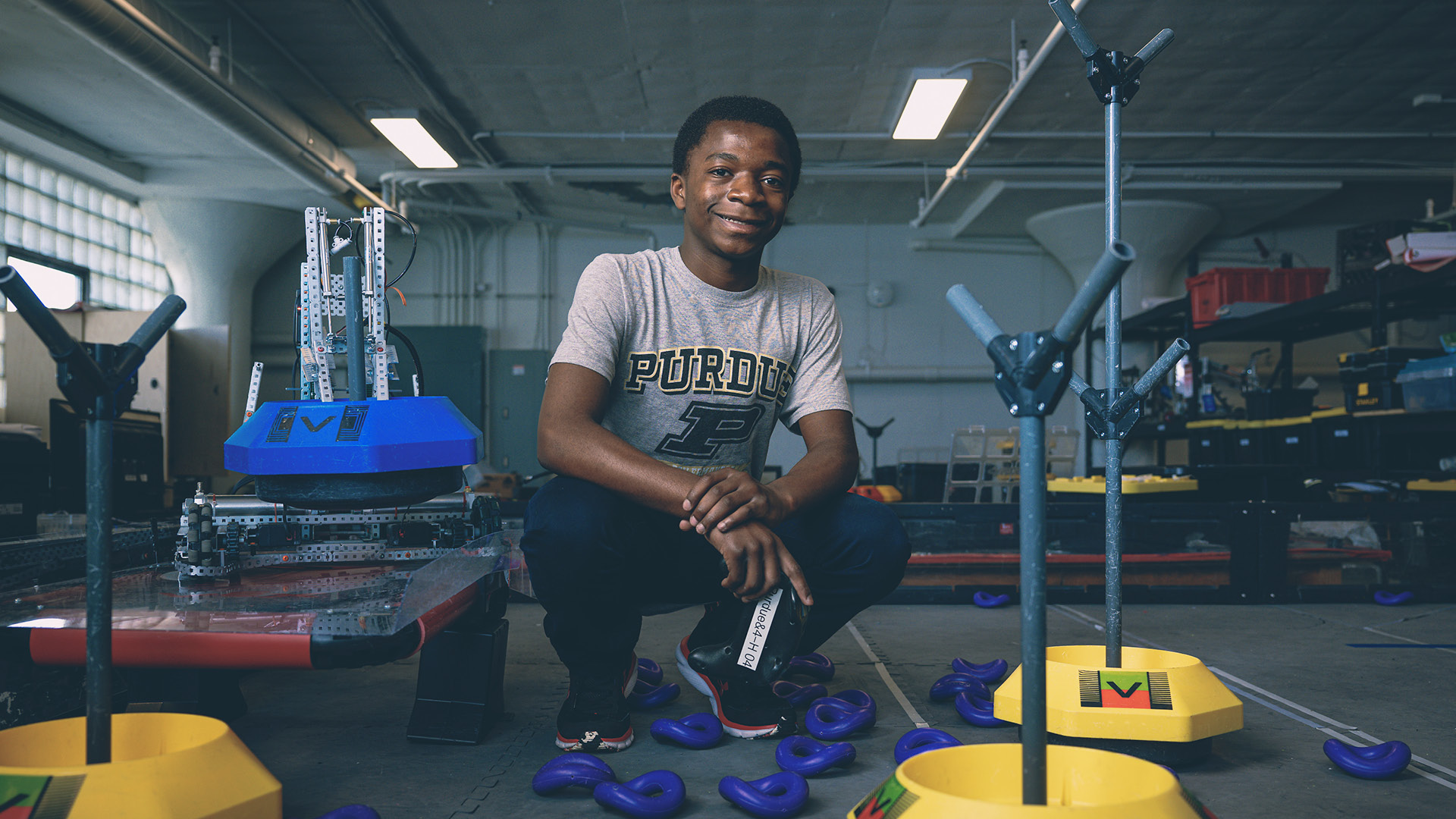 Asumani Gregoire Kalupala, a freshman at Purdue Polytechnic High School Schweitzer Center at Englewood in Indianapolis, is with his team’s VEX robot. He will be representing PPHS at the VEX Robotics World Championships in Dallas in May. (Purdue University photo/Charles Jischke)