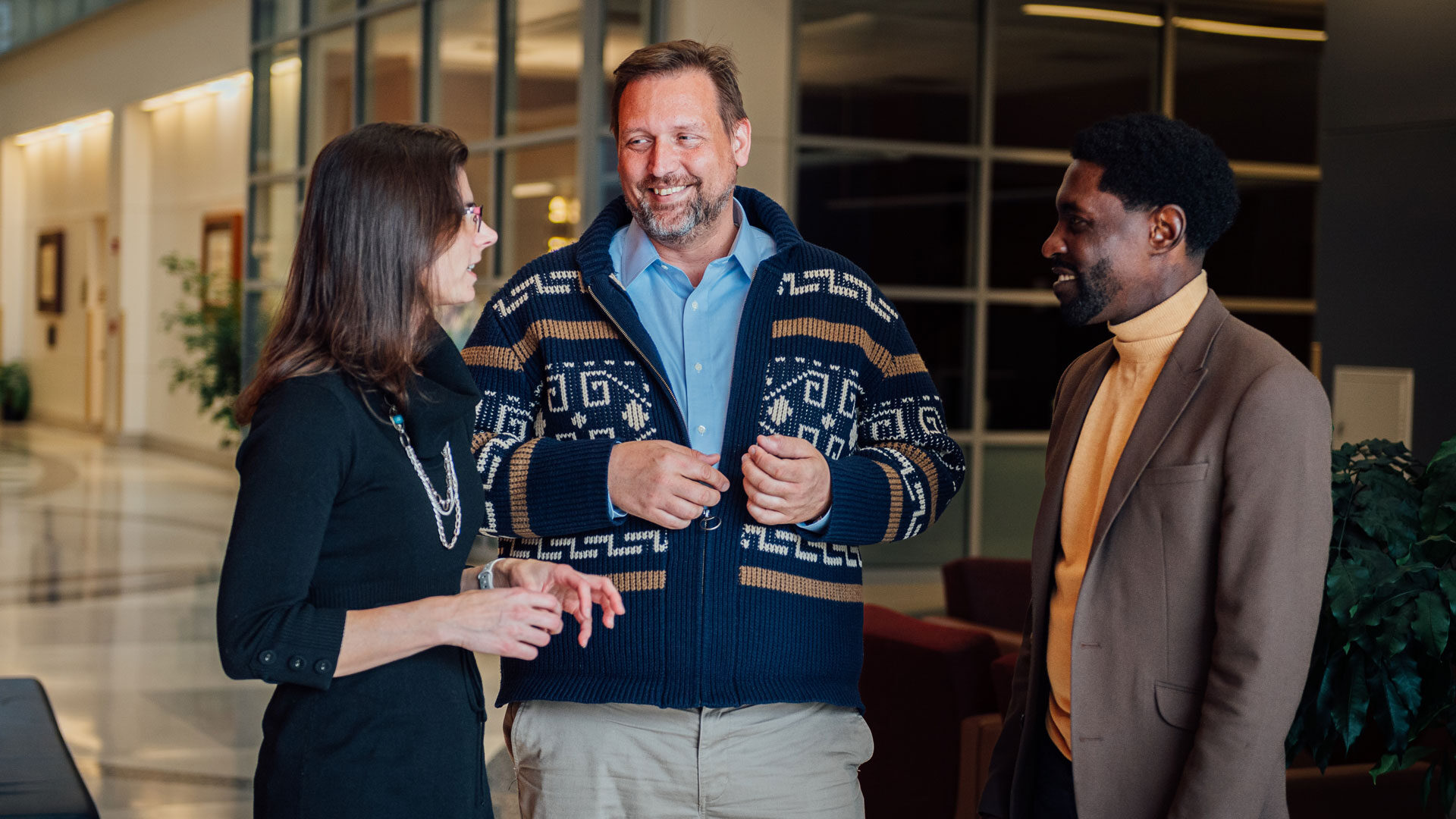 David Umulis, center, chats with biomedical engineering faculty members Jacqueline Linnes, left, and Leo Green, right, at Purdue’s Martin C. Jischke Hall of Biomedical Engineering. (Photo by Jon Garcia/Purdue Marketing and Communications)