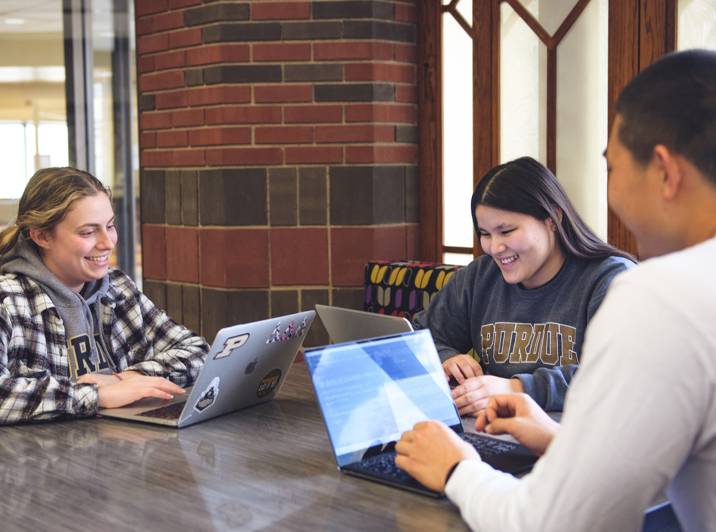 Annie Jancaric, Rose Wilfong and Cai Chen work together in a study space in Hillenbrand Hall.