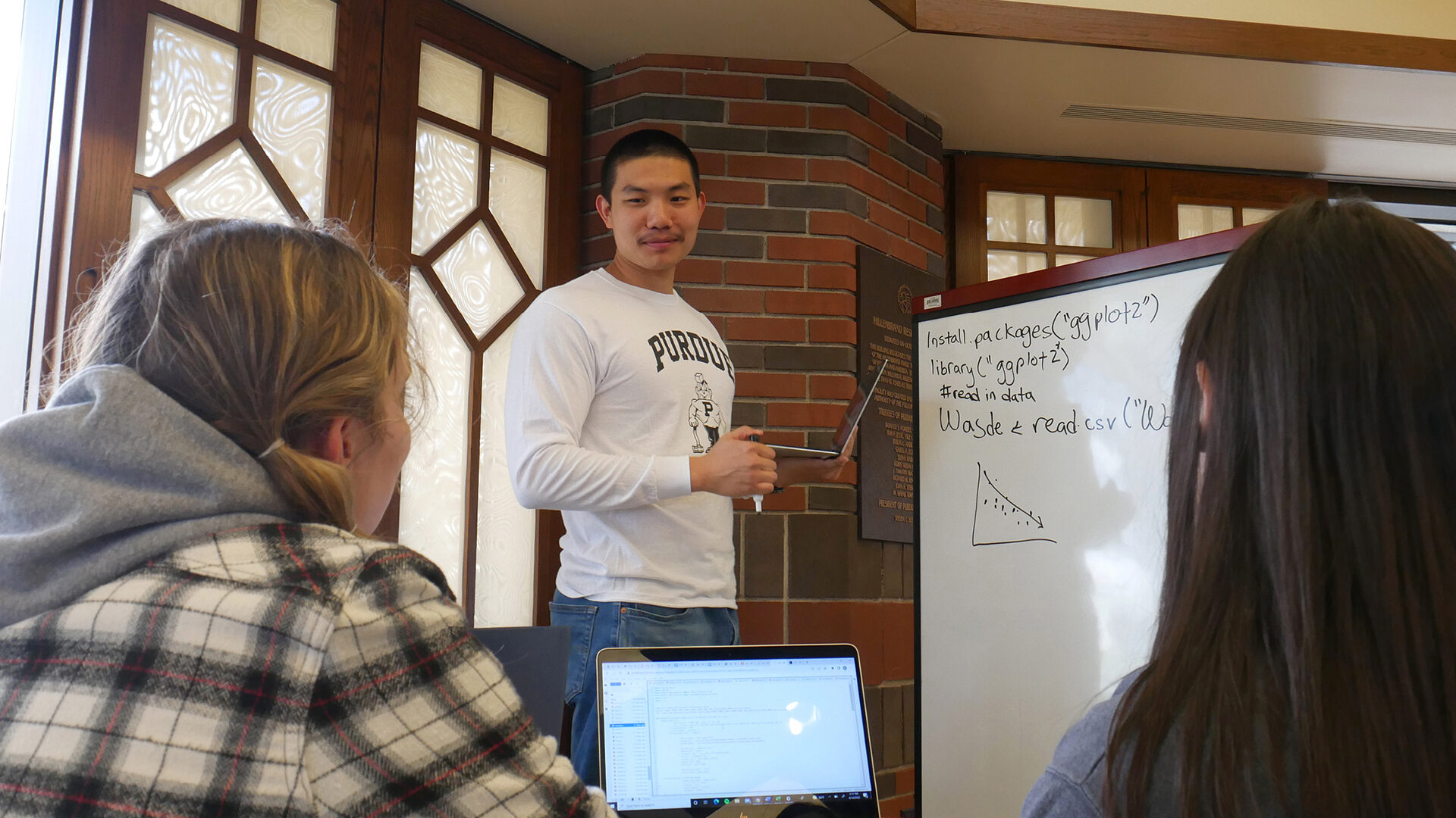 Annie Jancaric, Cai Chen and Rose Wilfong brainstorm ideas together in Hillenbrand Hall.