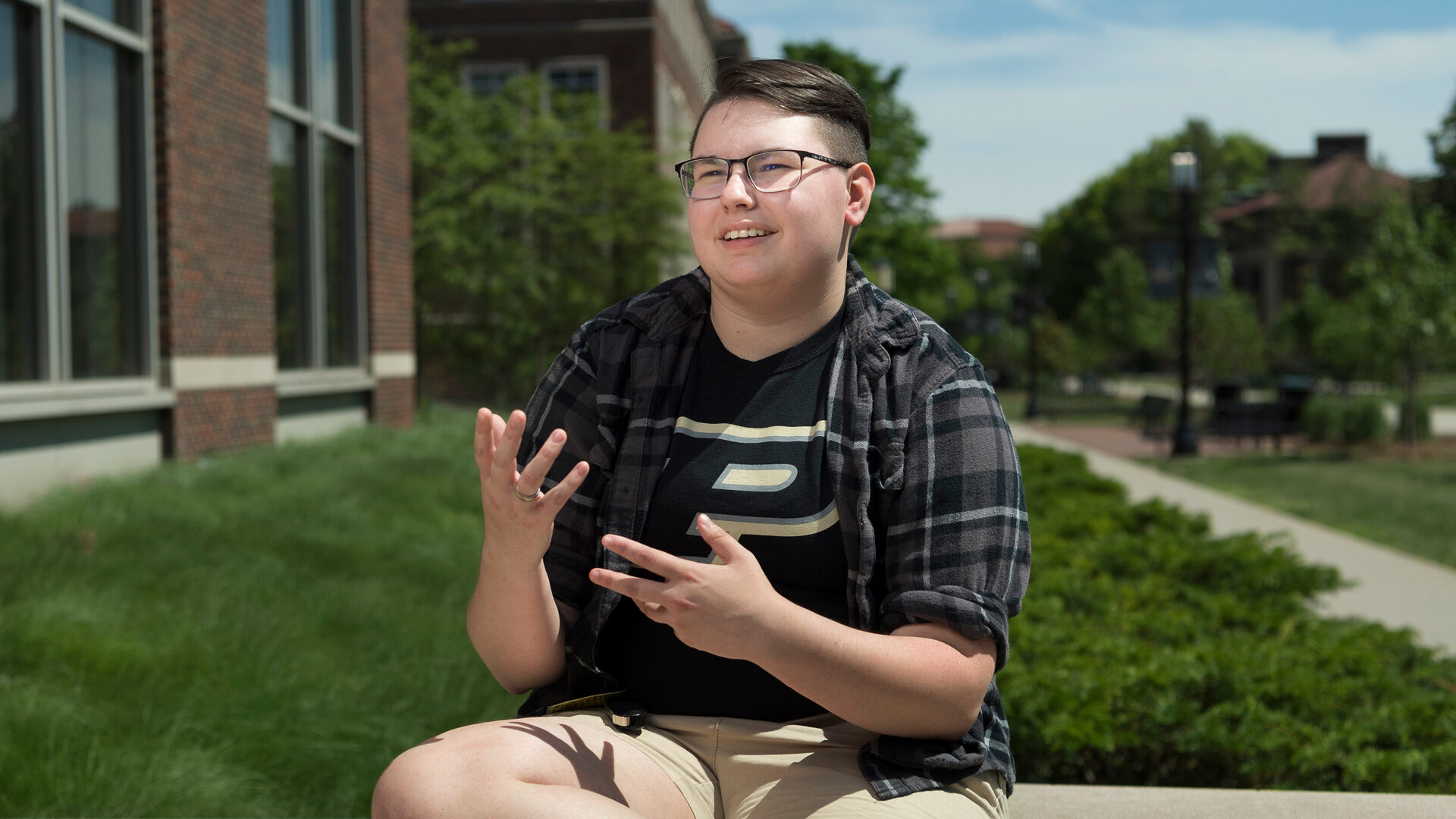 Elise Doan, wearing a Purdue shirt, stands on campus and is smiling and looking to the right of the frame.