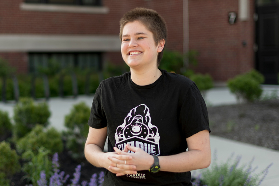 Audrey Williams, wearing a Purdue shirt, stands outside and is smiling, facing to the left of the frame.