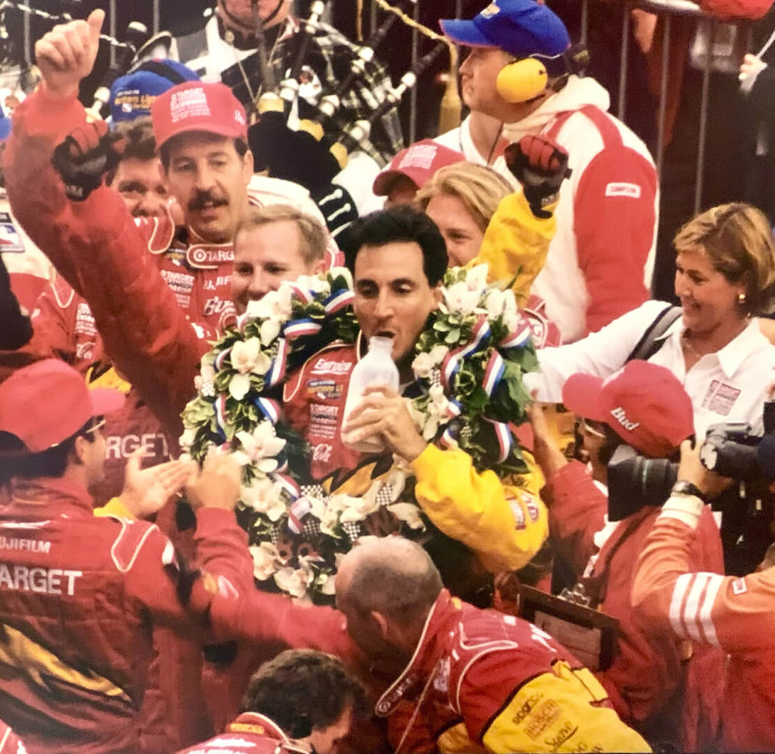 Bill Pappas takes a drink of milk in Victory Lane at the 2000 Indy 500 following Juan Pablo Montoya’s victory.