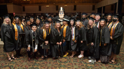 Purdue University Global graduates celebrate with mascot Purdue Pete.