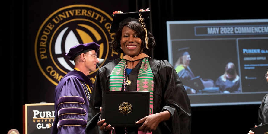 Sheila Taylor holds her Purdue University Global diploma.