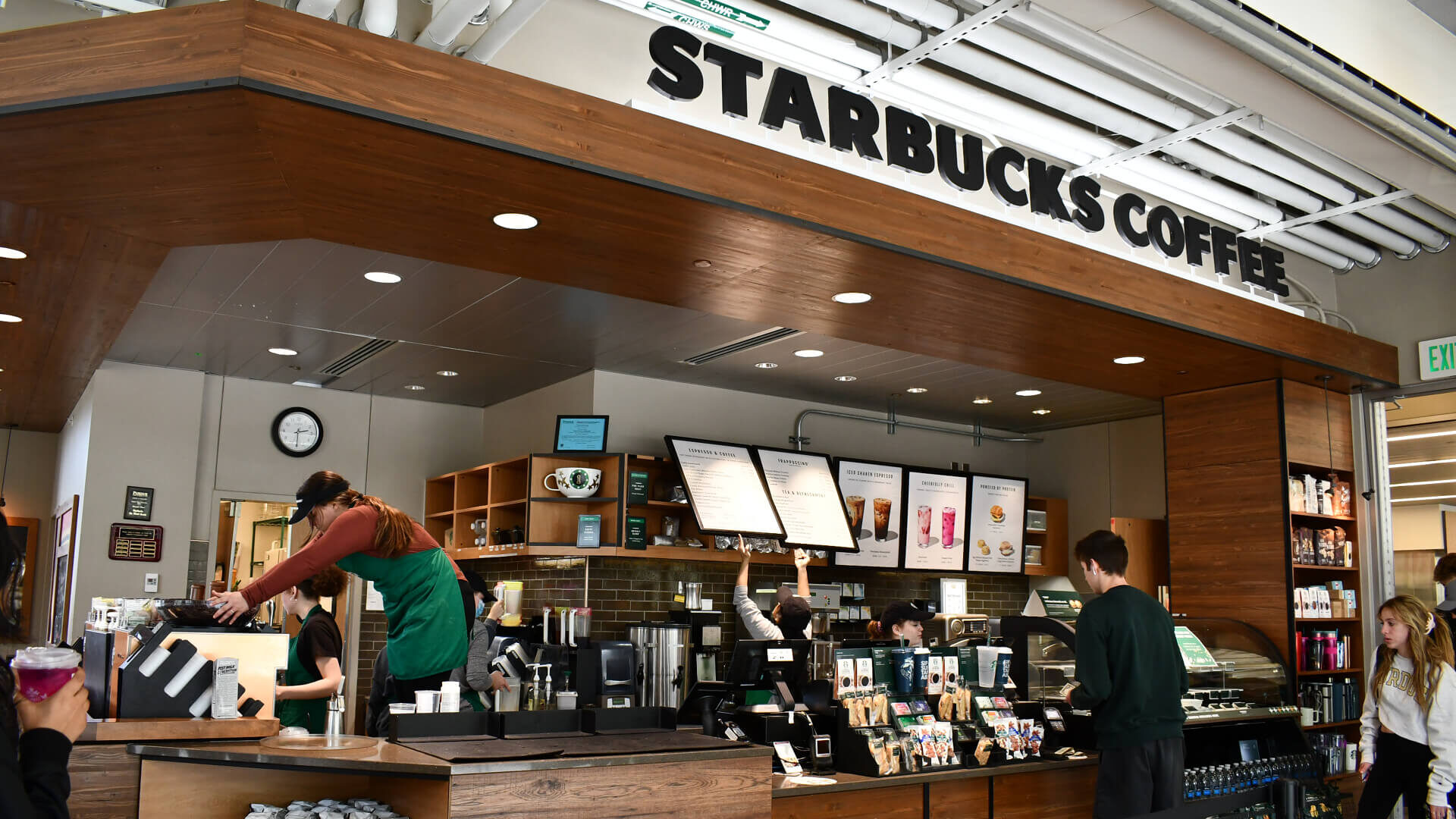 Student workers are preparing coffee for people on campus at the Third Street Starbucks.