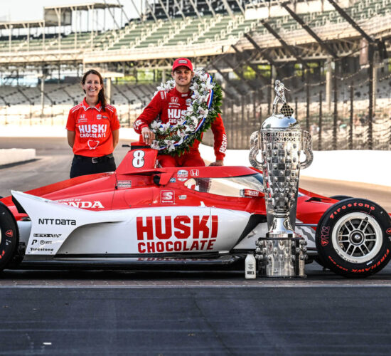 Angela Ashmore and IndyCar driver Marcus Ericsson, with Chip Ganassi Racing’s No. 8 Huski Chocolate Honda