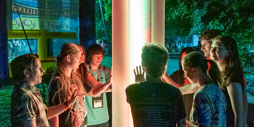 BGR participants touch the “A Warm Light for All” art installation.