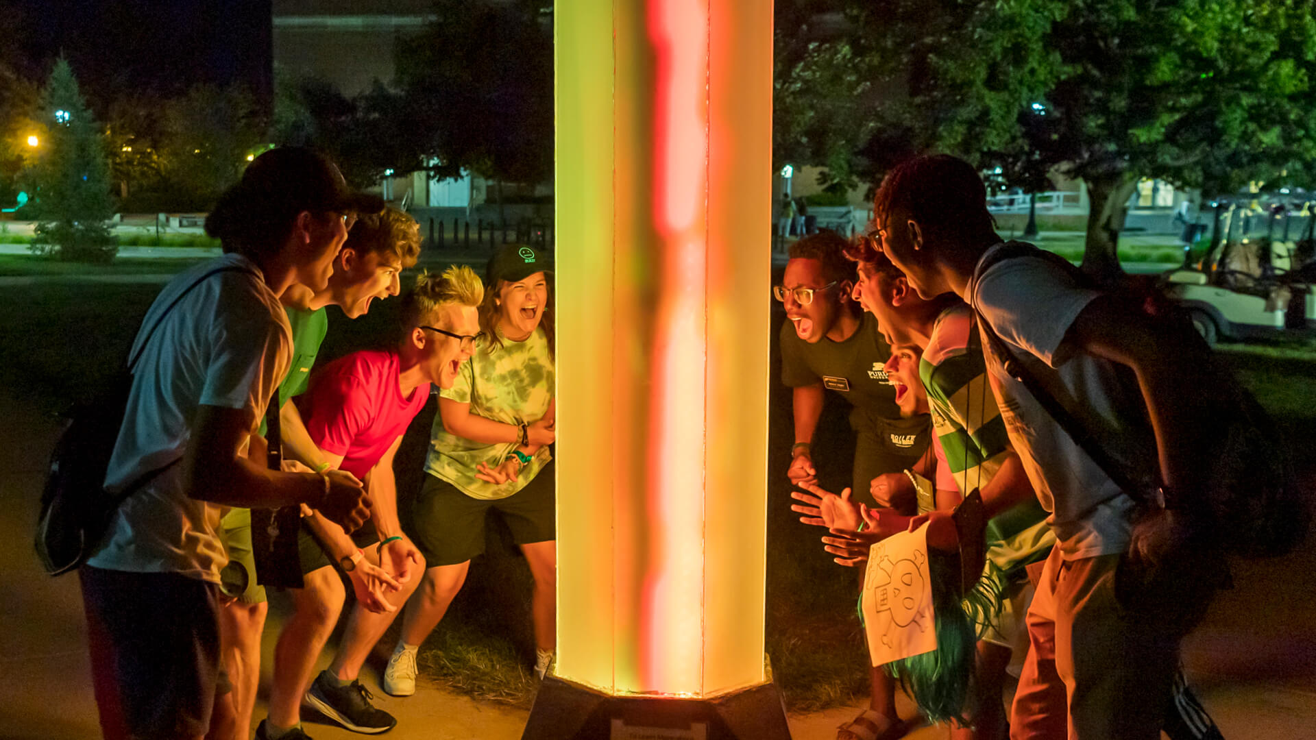 Boiler Gold Rush students gather around the “A Warm Light for All” art installation