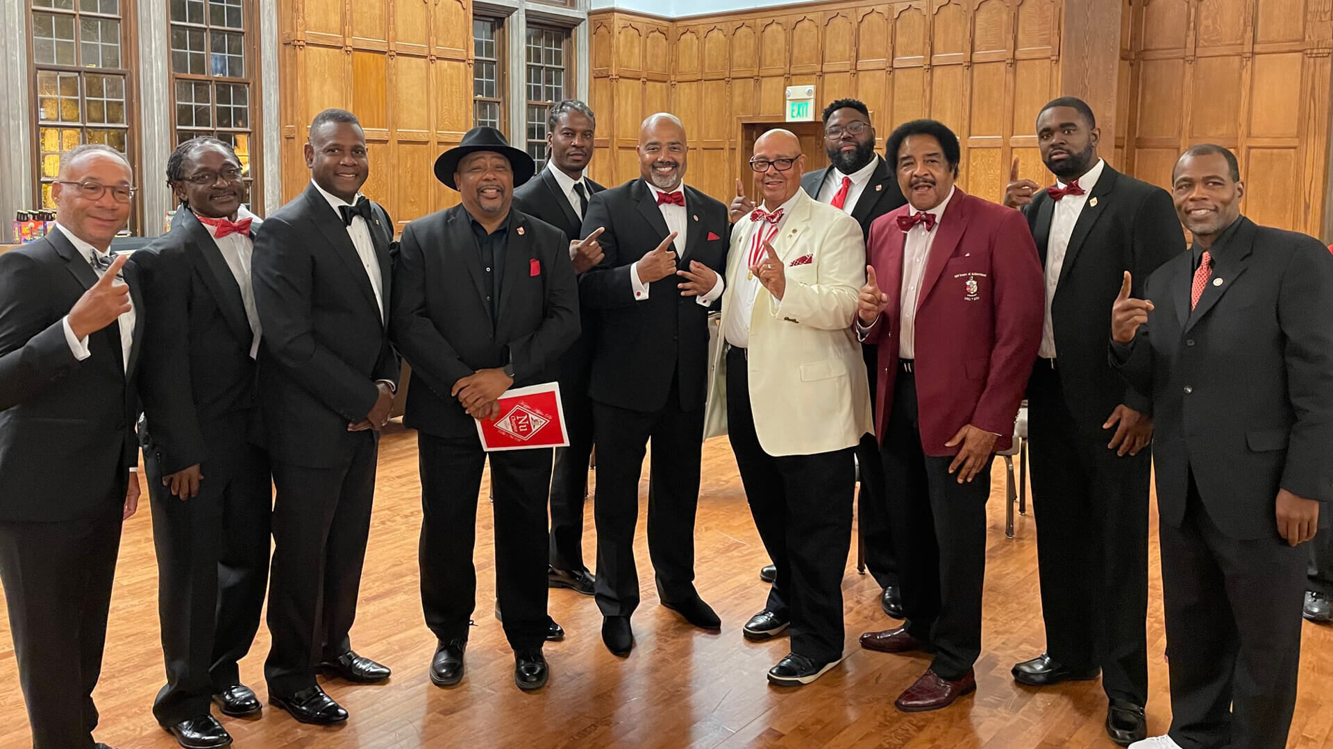 Maurice Markey poses with nine Kappa Alpha Psi brothers at the Purdue Memorial Union, several showing the Kappa Alpha Psi hand sign