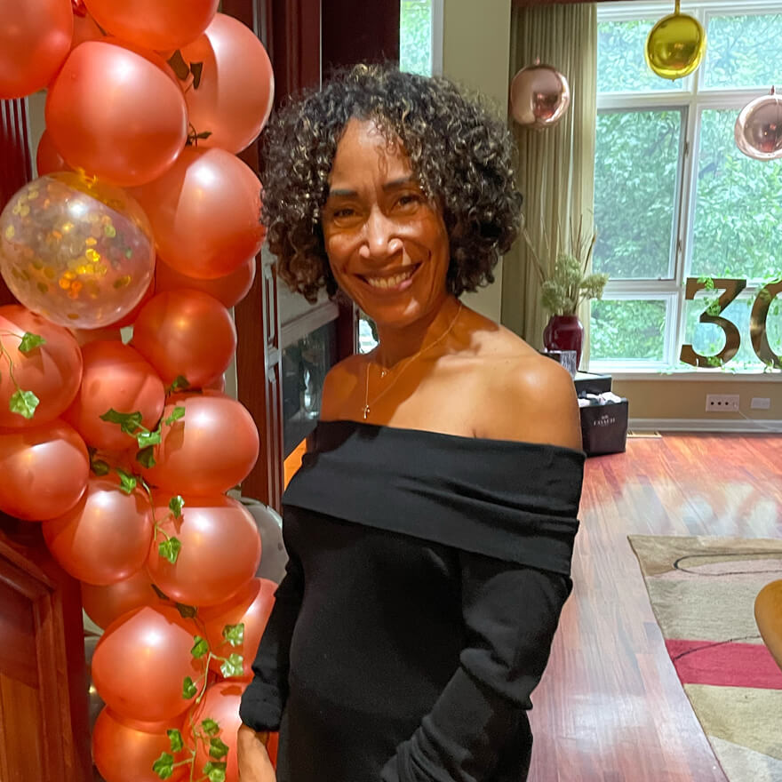 Tamara Markey smiles at an Alpha Kappa Alpha event, balloons in the background