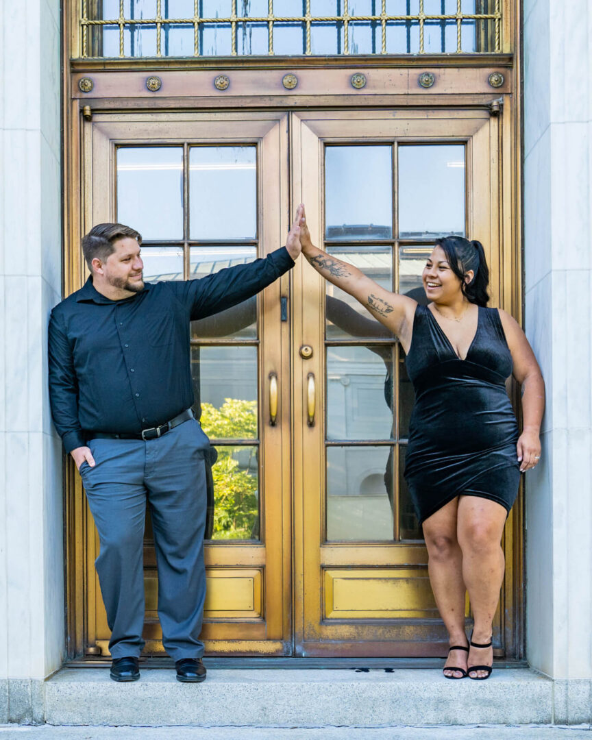 James and Tracy Ly Scott high five during their visit to Washington, D.C., to attend Purdue Global’s summer 2022 commencement.