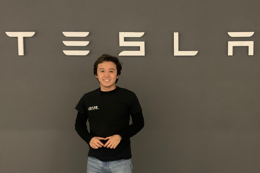 Nick poses by the Tesla sign (photo provided)