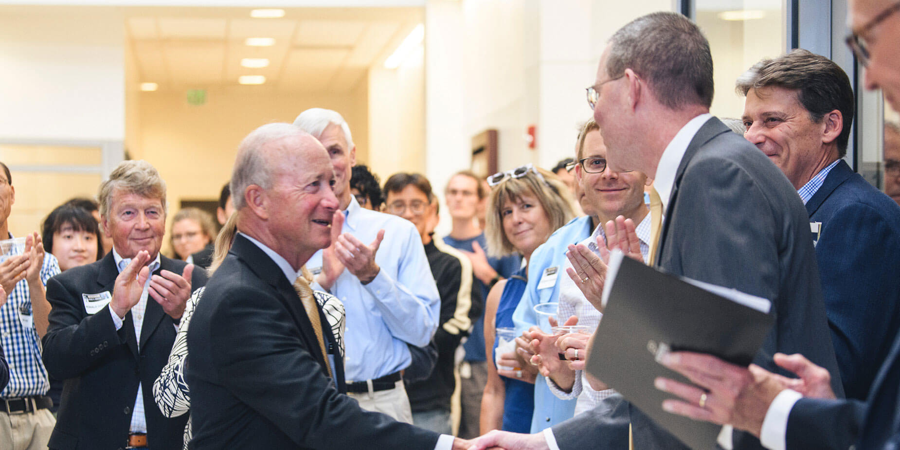Mitch Daniels and George Wodicka shake hands at the Sept. 9 event.