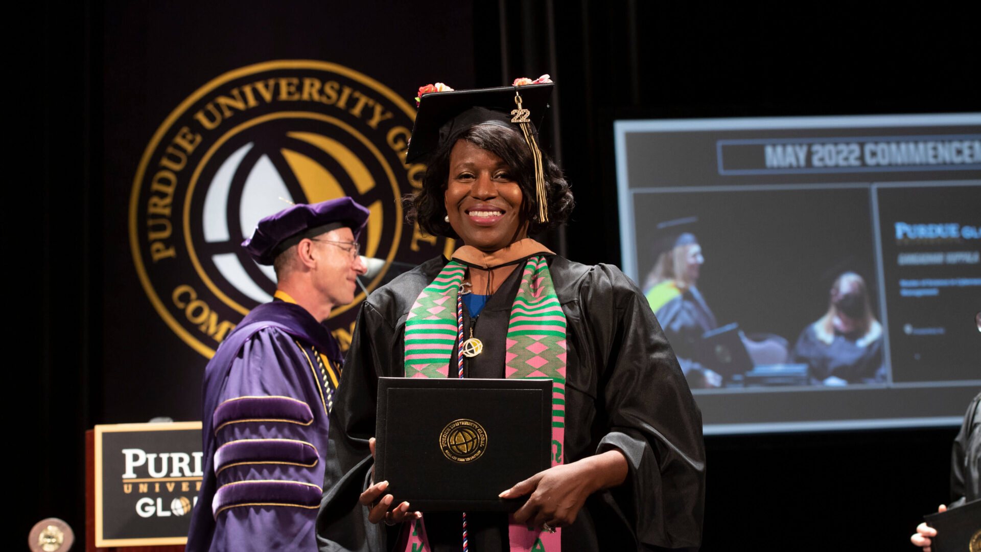 Sheila Taylor holds her Purdue University Global diploma.