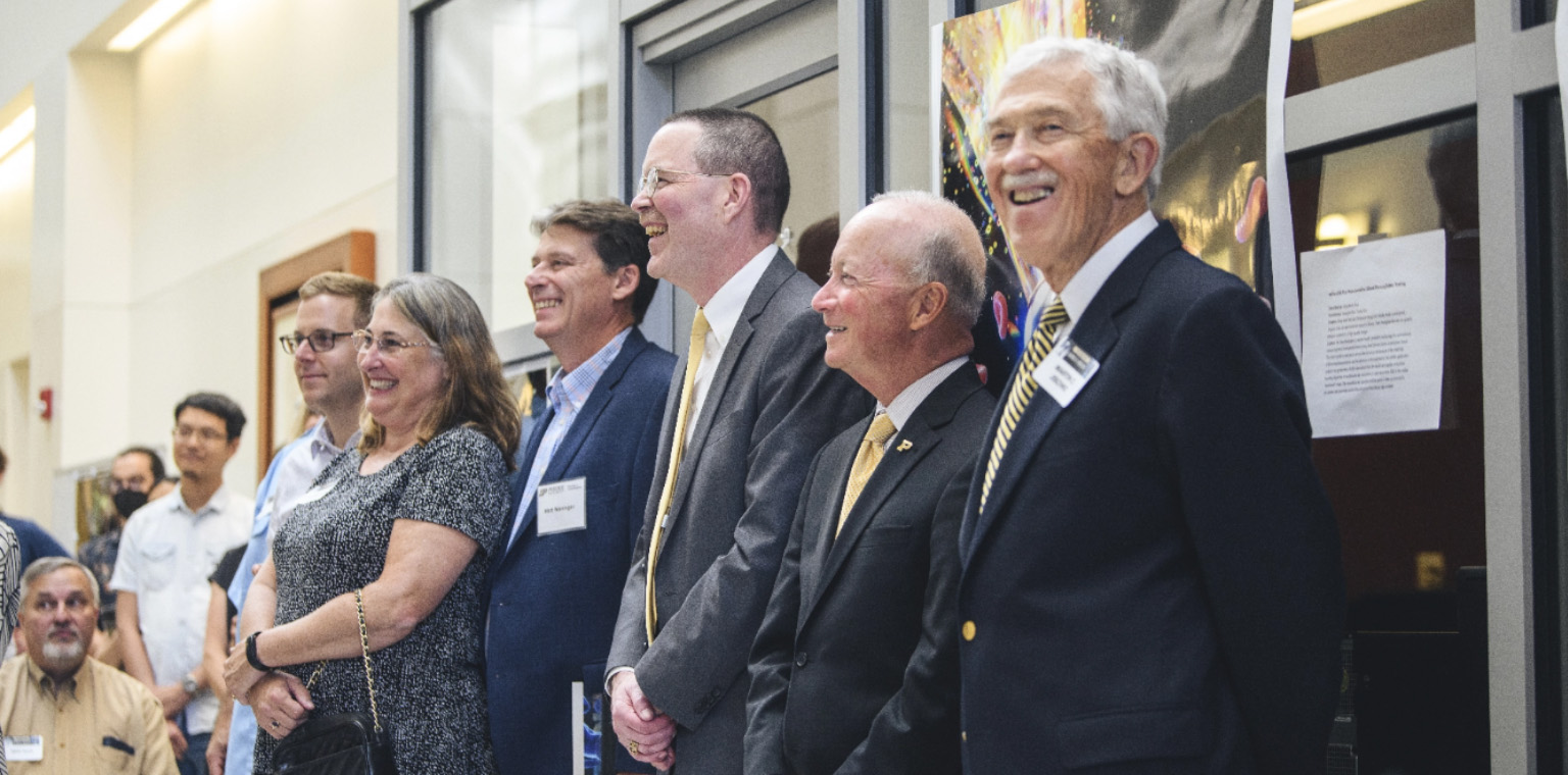 Purdue presidents Martin Jischke, far right, and Mitch Daniels, second from right, were among the well-wishers at the Sept. 9 celebration of George Wodicka.