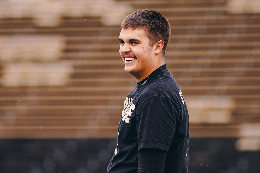 Aidan O’Connell stands on the football field.