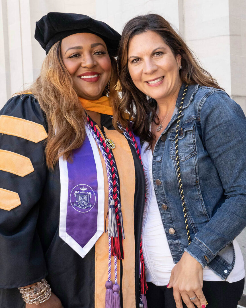 Purdue Global Doctor of Nursing Practice graduate Ashlee Tippins, left, celebrates with Dean Melissa Burdi at the August 2022 commencement.