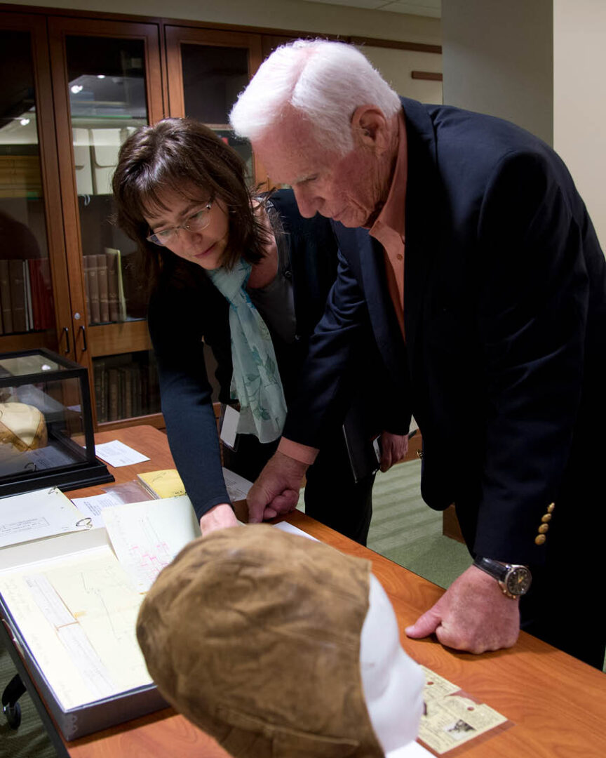 Tracy Grimm, Purdue’s Barron Hilton Archivist for Flight and Space Exploration, reviews documents with astronaut Eugene Cernan at Purdue Archives and Special Collections.