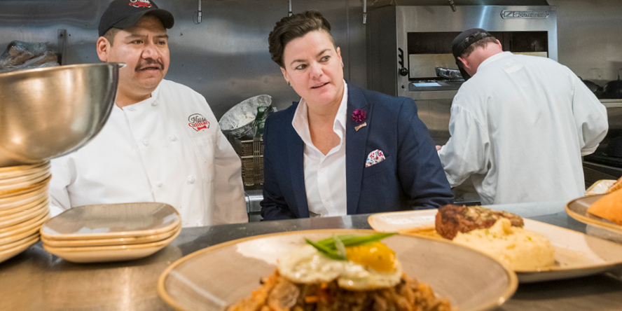 Leanna Chroman chats with a kitchen worker at HC Tavern + Kitchen.