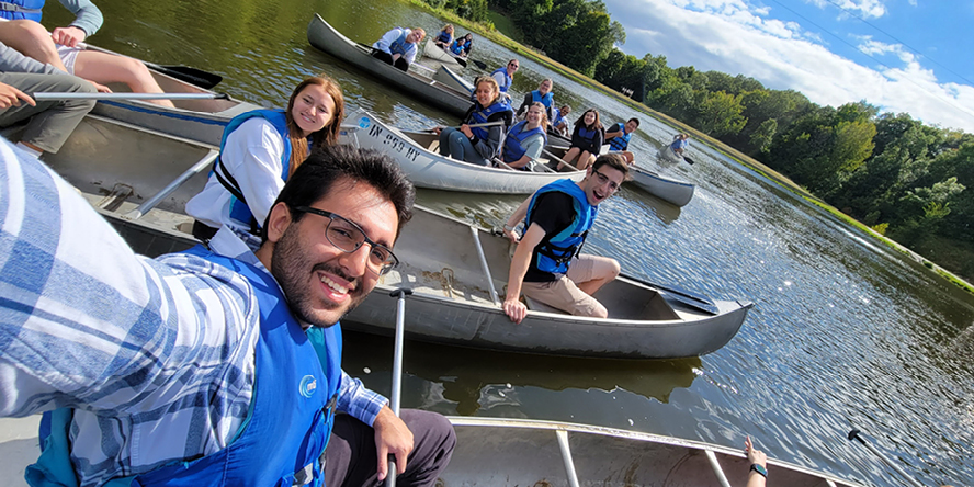 Parsia Bahrami takes a selfie in a canoe alongside other students.