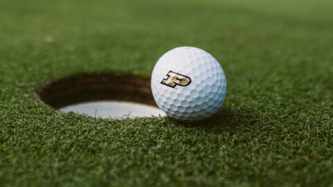 A Purdue golf ball on a golf course.