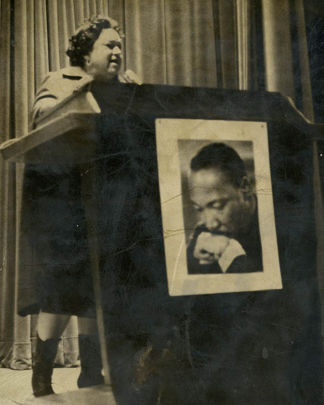 Helen Bass Williams speaks at a lectern adorned with a photo of the Rev. Martin Luther King Jr.