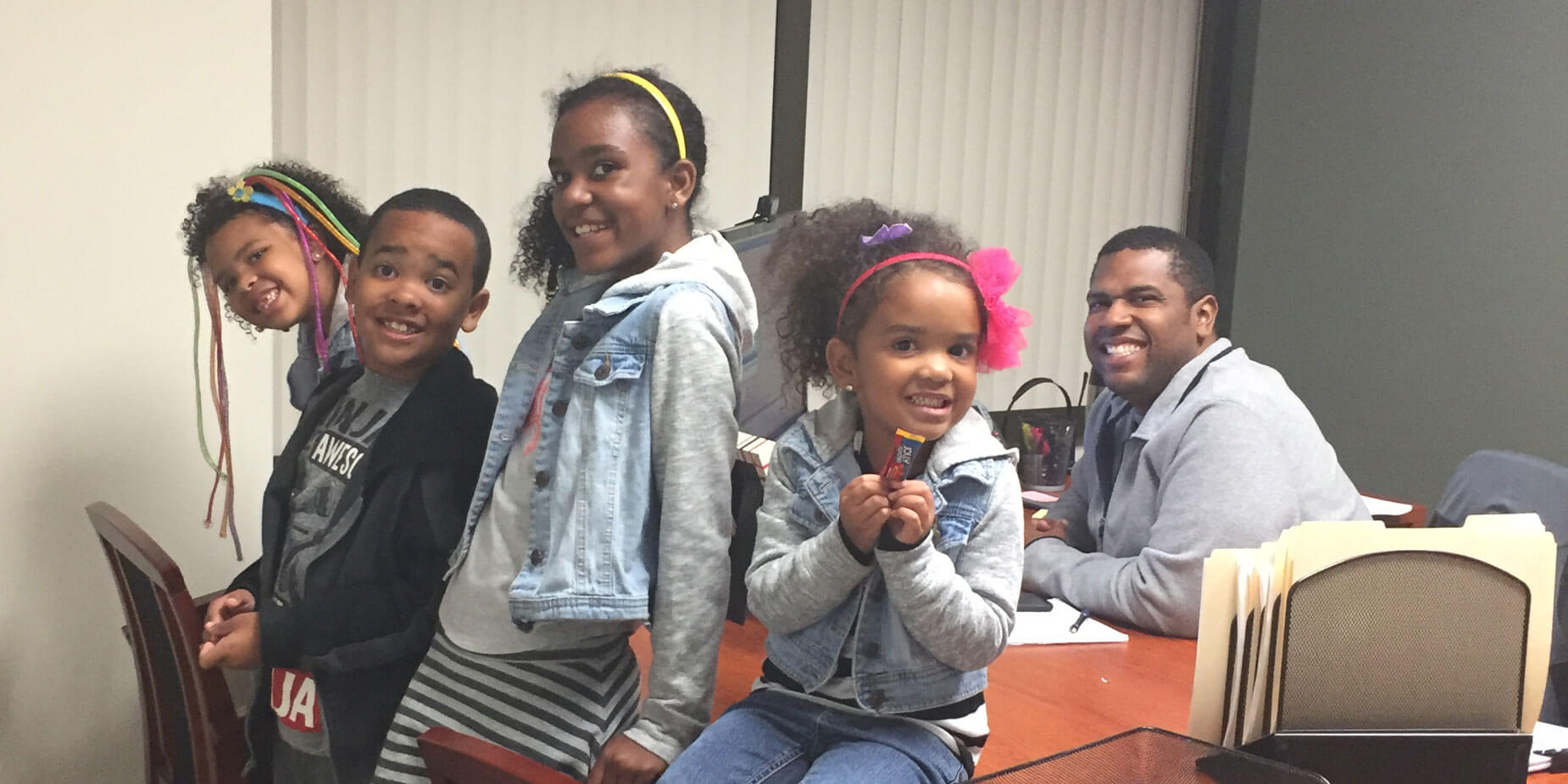 Dolan Williams' four children sit on his office desk.