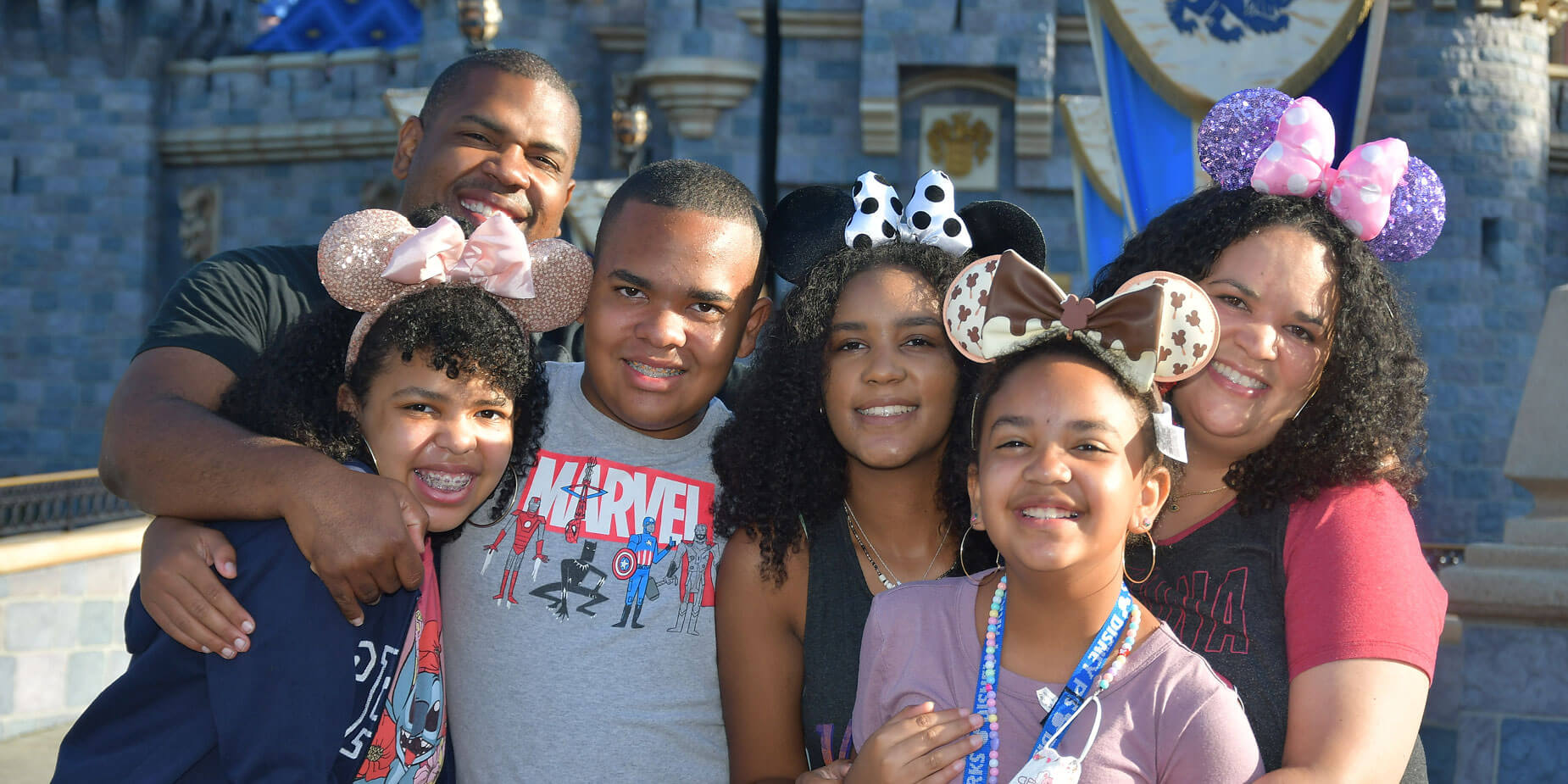 Dolan Williams with his four kids and wife in front of the Disneyland castle in Anaheim, California.
