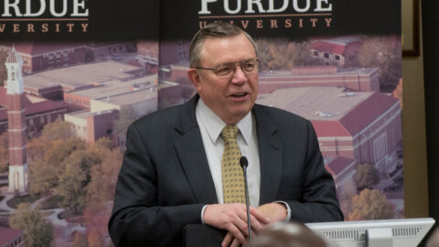 Vic Lechtenberg speaks into a microphone at a Purdue event.