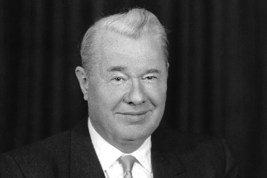 R.B. Stewart smiles for a staff photo in front of a dark background.