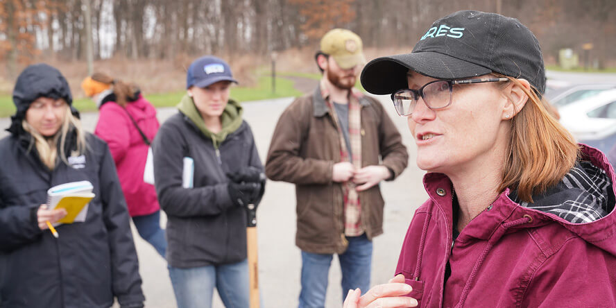 Laura Bowling talking with students outside.