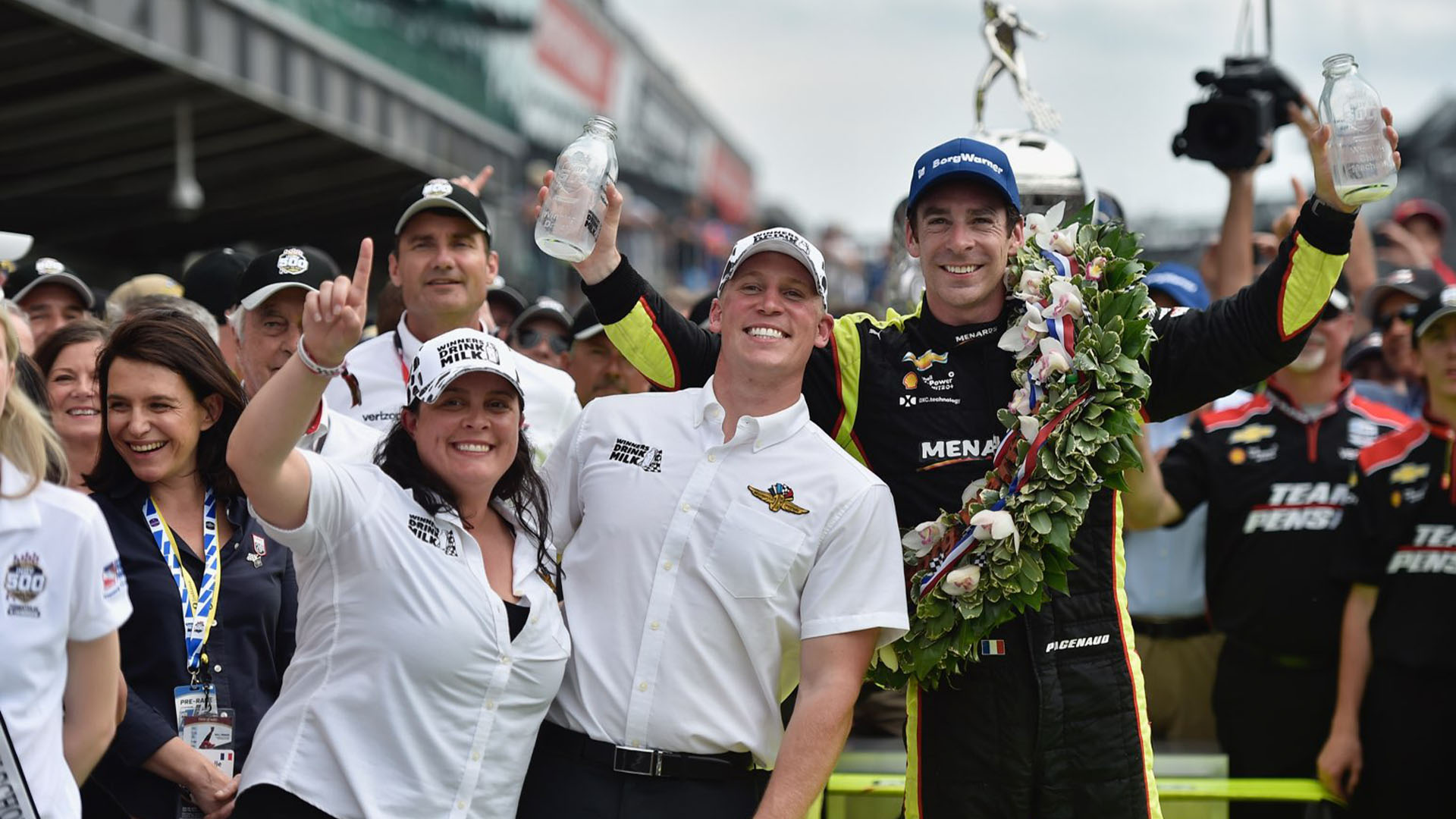 Dairy farmers Jill Houin and Andrew Kuehnert celebrate with driver Simon Pagenaud after Pagenaud’s win in the 2019 Indianapolis 500.