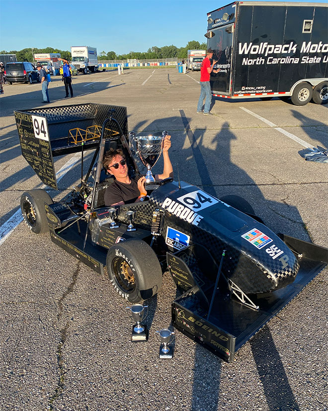 MacNab seated in his winning vehicle with the second-place trophy at the Formula SAE Michigan.
