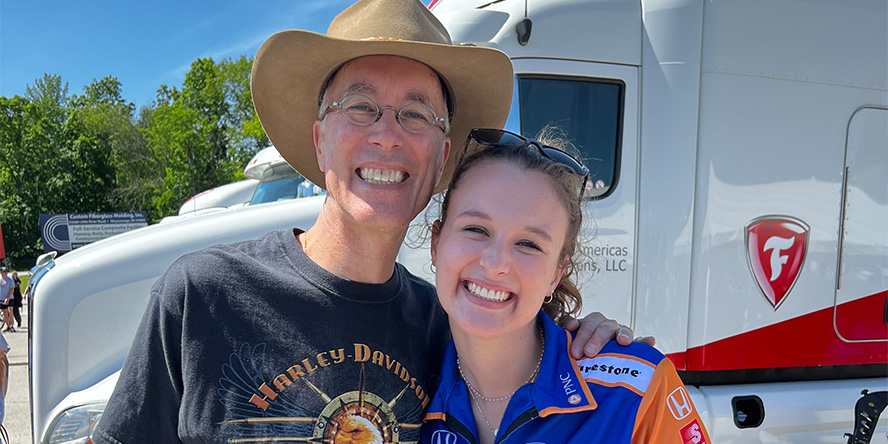 Jennifer Short smiling and standing next to her father.