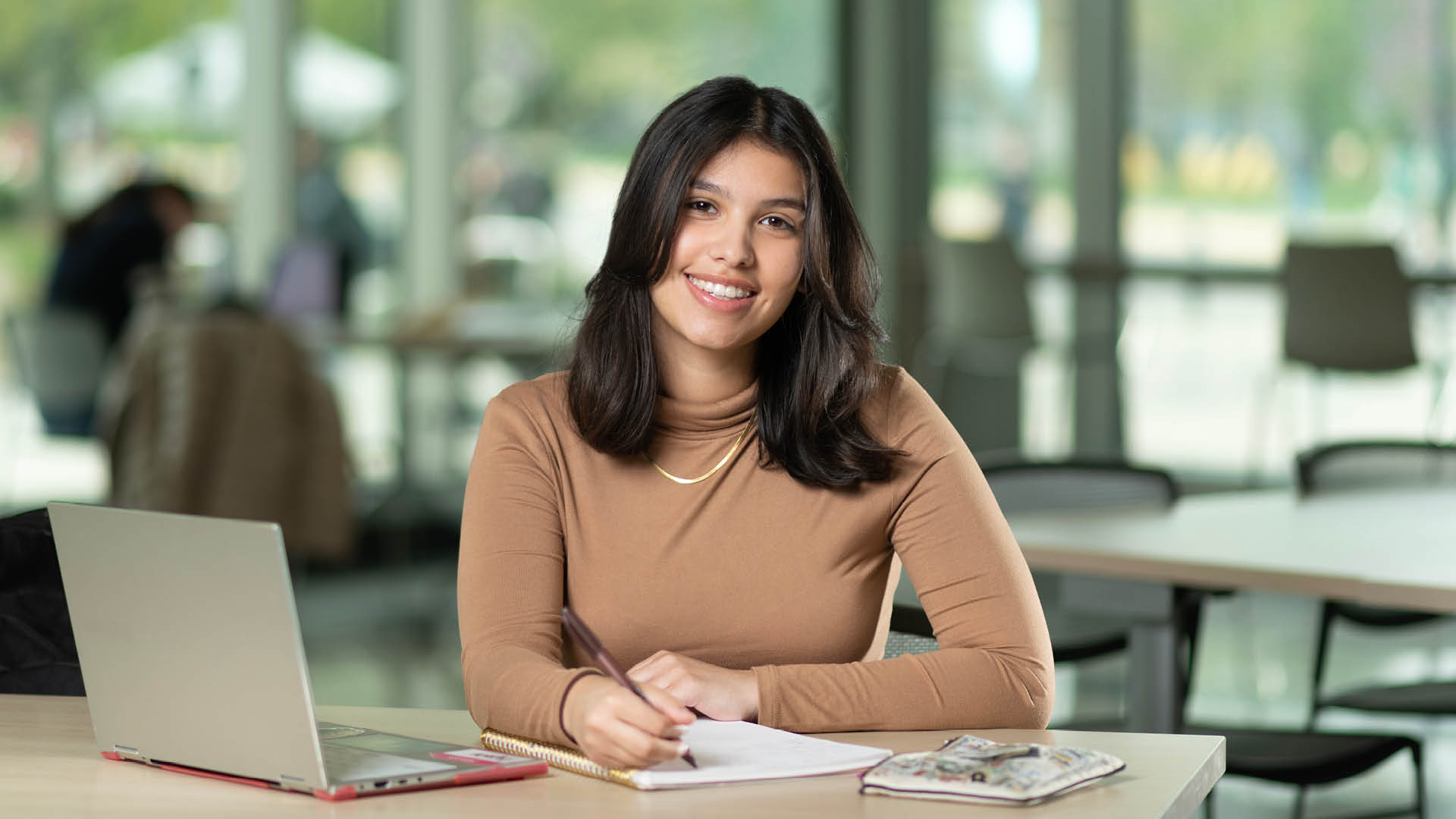 Alyssa Rodriguez at desk.