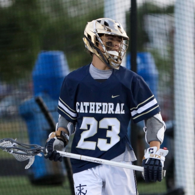 Kinder playing lacrosse in high school.