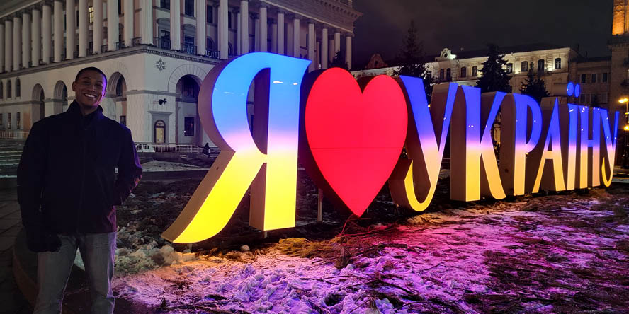 Jan. 20, 2022, Justin Scott standing next to an “I Love Ukraine” sign in Maidan Nezalezhnosti, the central square of Kyiv, the capital city of Ukraine, about one month before Russia invaded.