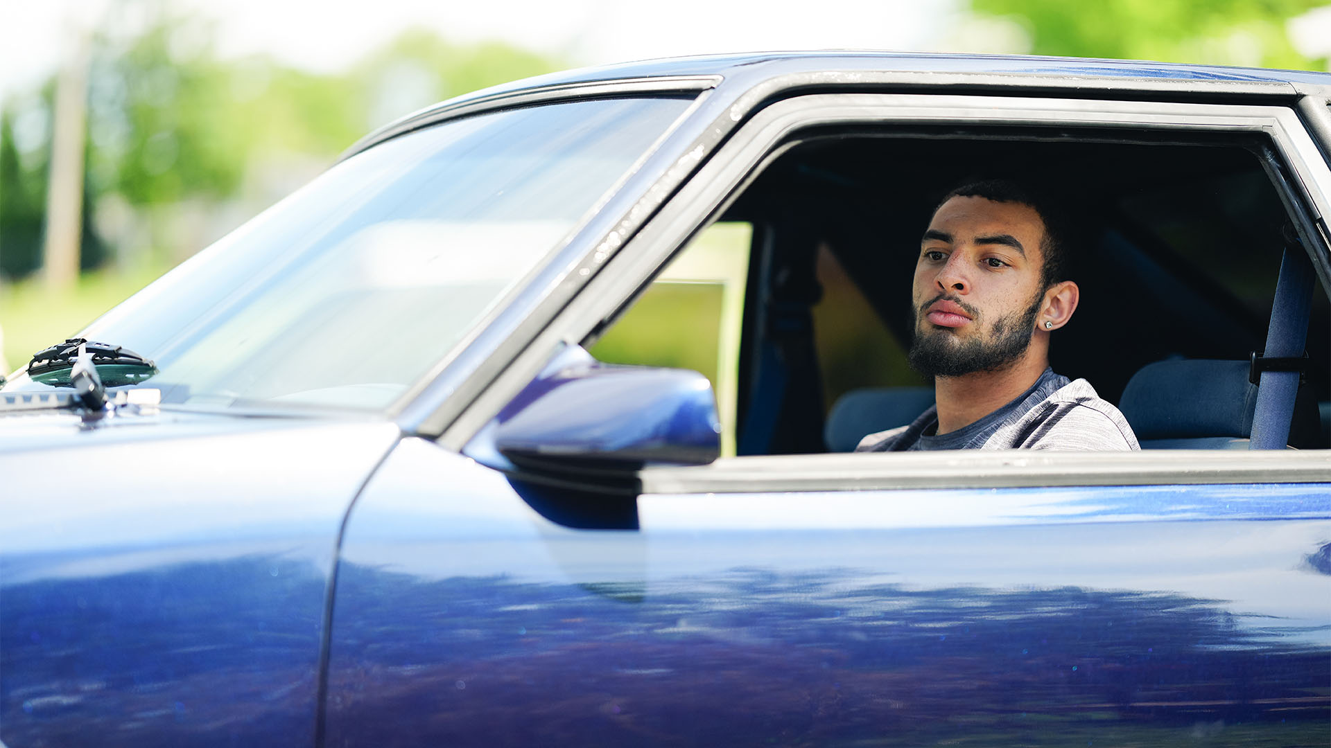 Devin Mockobee behind the wheel of the 1993 Ford Mustang he calls “Blue”