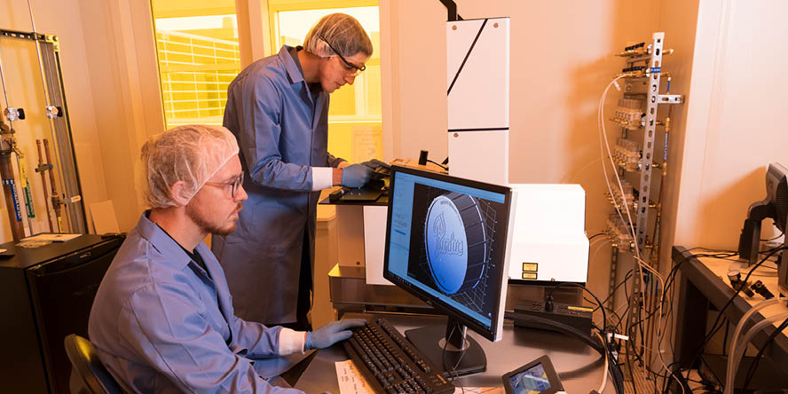 Aaron Davis and Georges Adam work with the Nanoscribe Photonic Professional GT2 3D printer.