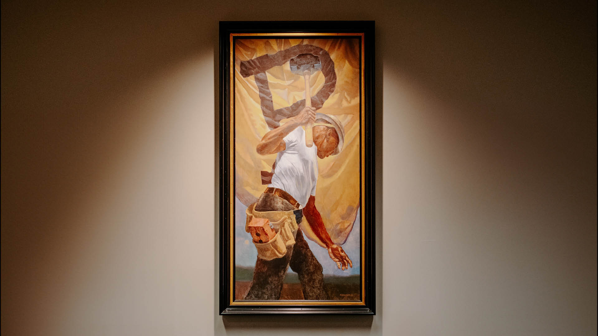 A painting of a boilermaker holding a hammer with a Purdue emblem in the background.