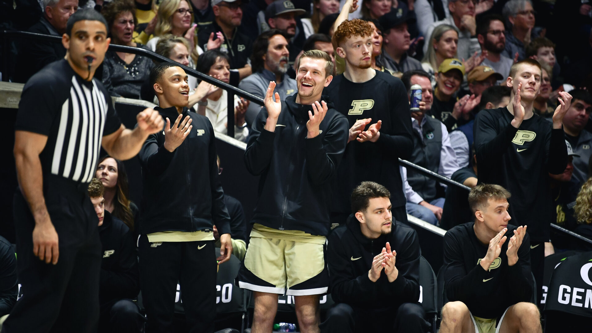 The Purdue men's basketball bench celebrates a positive play during action at Mackey Arena.
