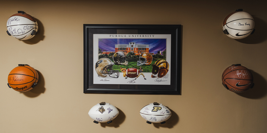 An autograph display wall features a print signed by former Purdue quarterbacks Drew Brees, Len Dawson and Bob Griese