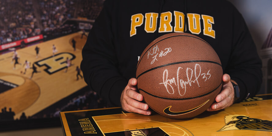 Don Hunt holds a basketball autographed by Purdue basketball great Brian Cardinal