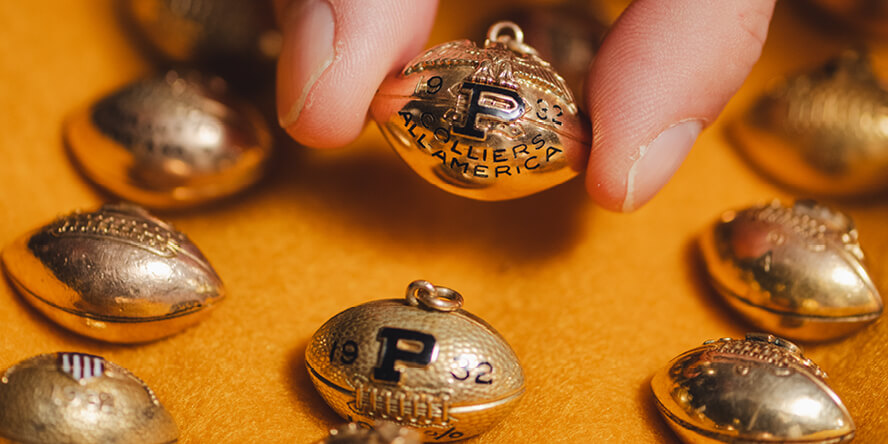 Gold charms presented to Purdue athletes for special achievements