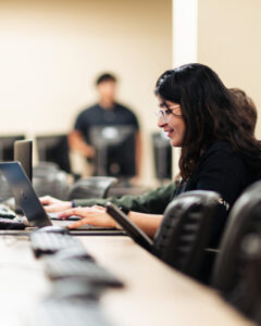 Ishita Sameer Bhedi typing on a laptop.