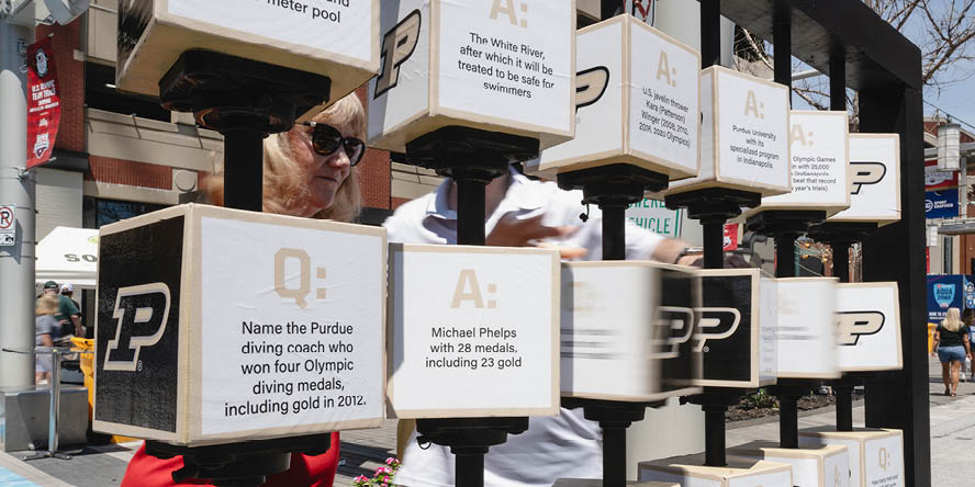 Purdue-branded tic tac toe board with Olympics and swimming questions and answers. 