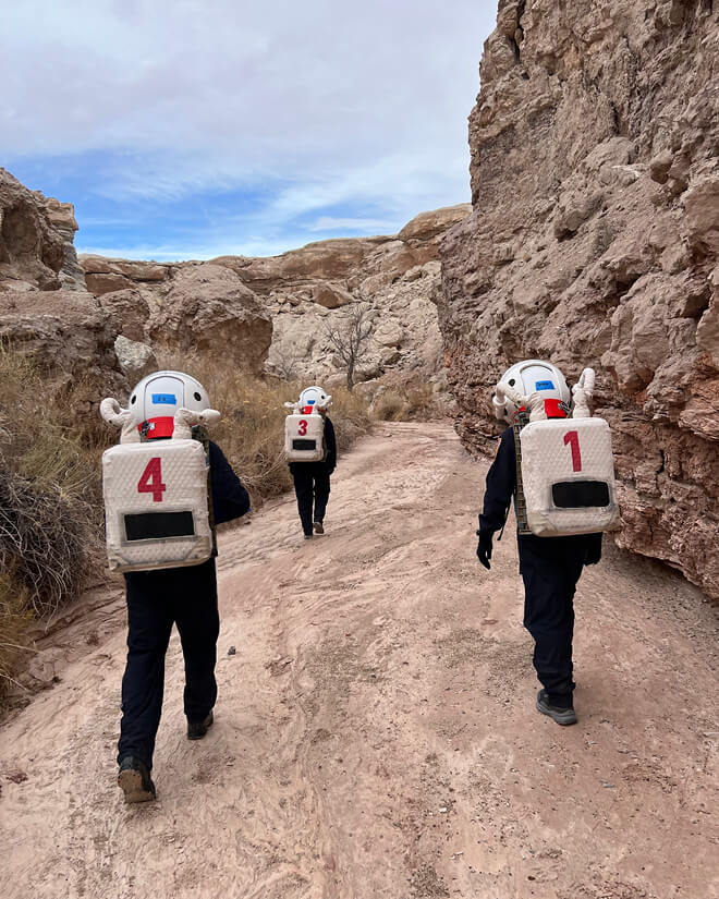 Purdue analog astronauts walking to an MDRS field research site